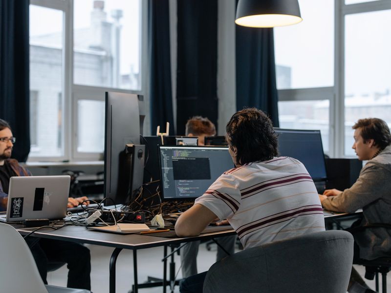 A team of developers working together in a modern tech office
